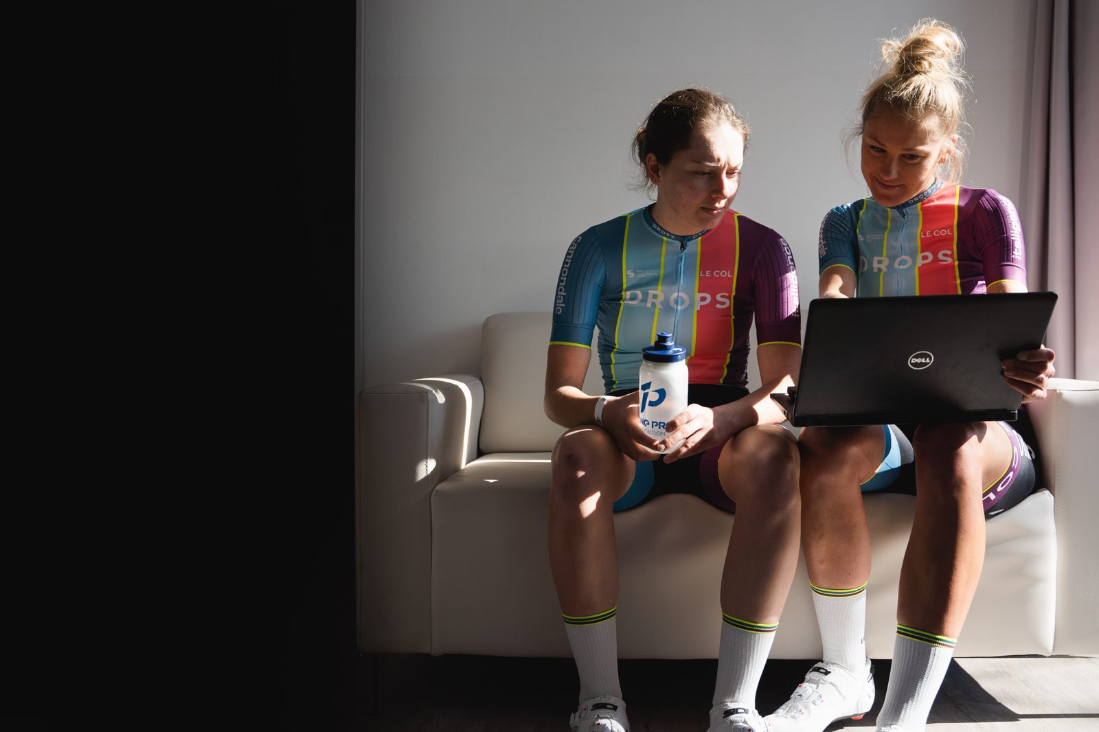 Joss Lowden reviewing training data on a laptop with an athlete